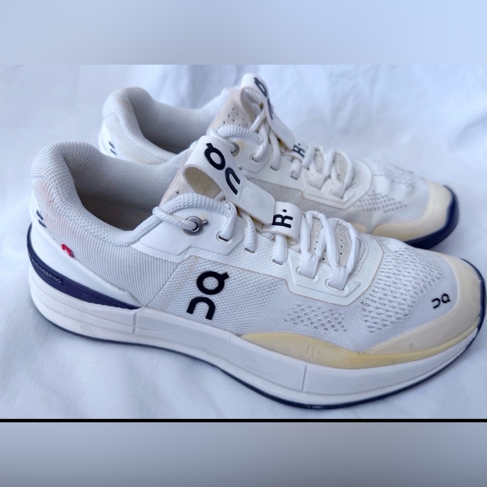 On Running White and Black Athletic Shoes